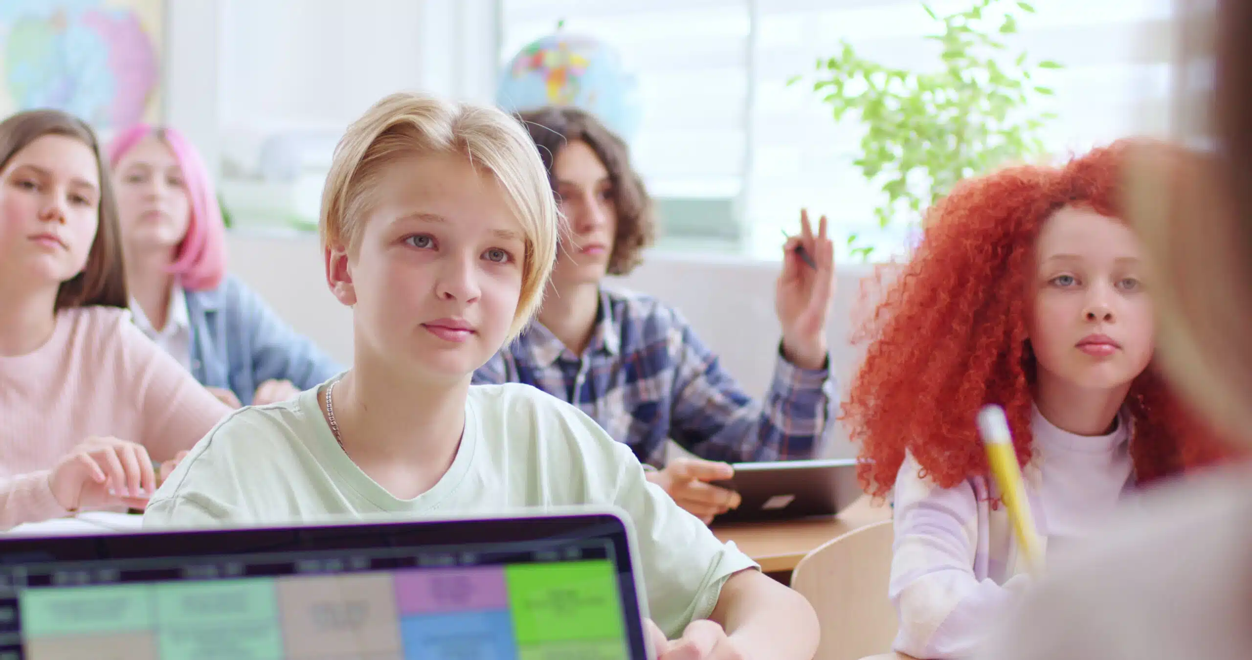 caucasian teen schoolboy sitting at desk in front of teacher and answering on question SBI 350891004 scaled